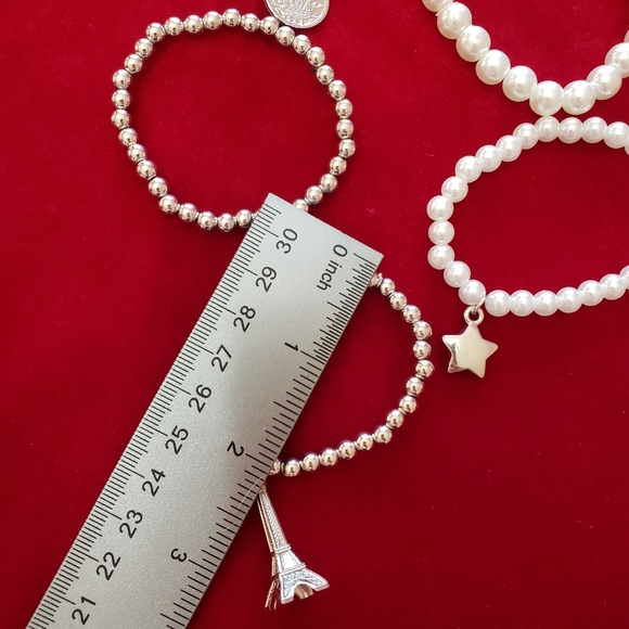 Multiple silver and white tone faux Pearl bracelets with charms - Picture 5 of 7